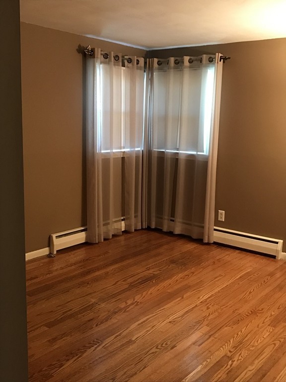 337 Westfield Road Holyoke, MA 01040 - Photo 9 of 13 a view of an empty room with wooden floor and a window