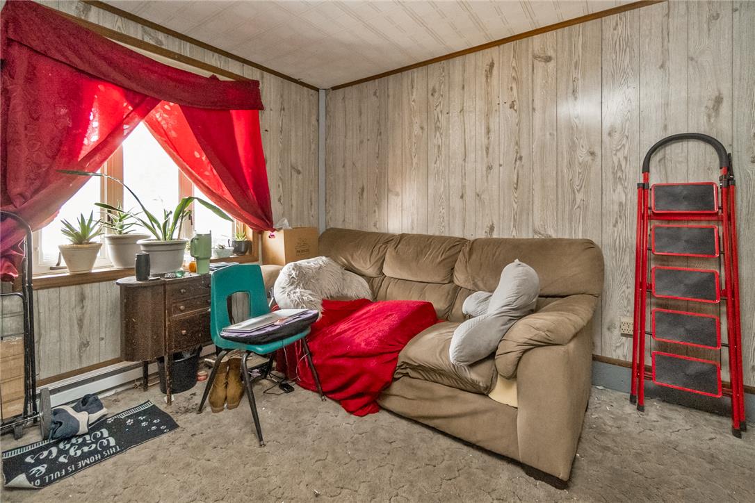 377 West Ridge Street Lansford, PA 18232 - Photo 31 of 39 Rustic wood paneling offers a distinctive backdrop in this cozy living space.