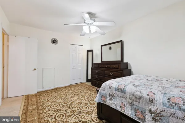 a bedroom with a bed and a dresser