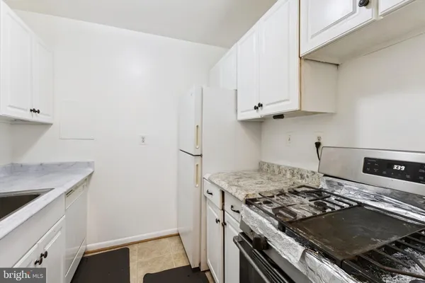 a stove top oven sitting inside of a kitchen