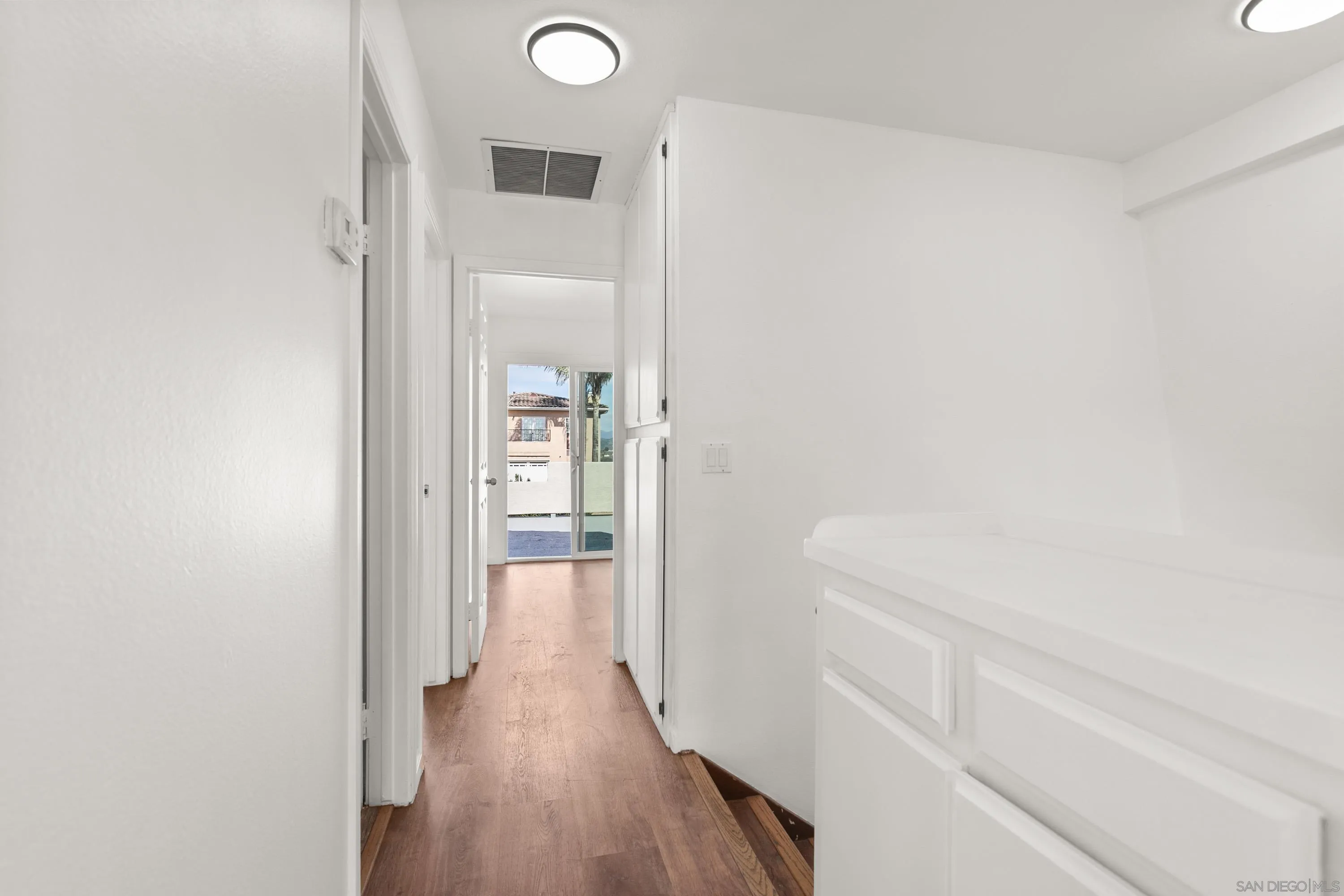 9811 Eucalyptus Street Spring Valley, CA 91977 - Photo 32 of 55 a view of a hallway with wooden floor and closet