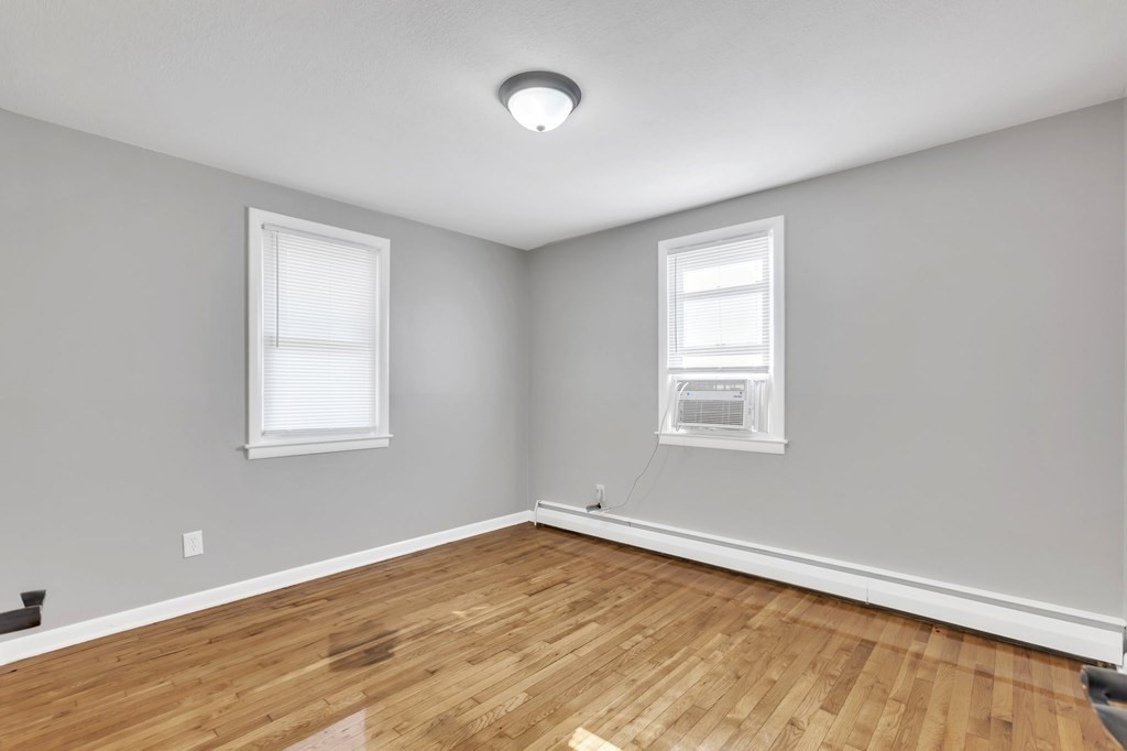 172 Garvey Drive Springfield, MA 01109 - Photo 11 of 28 wooden floor in an empty room with a window