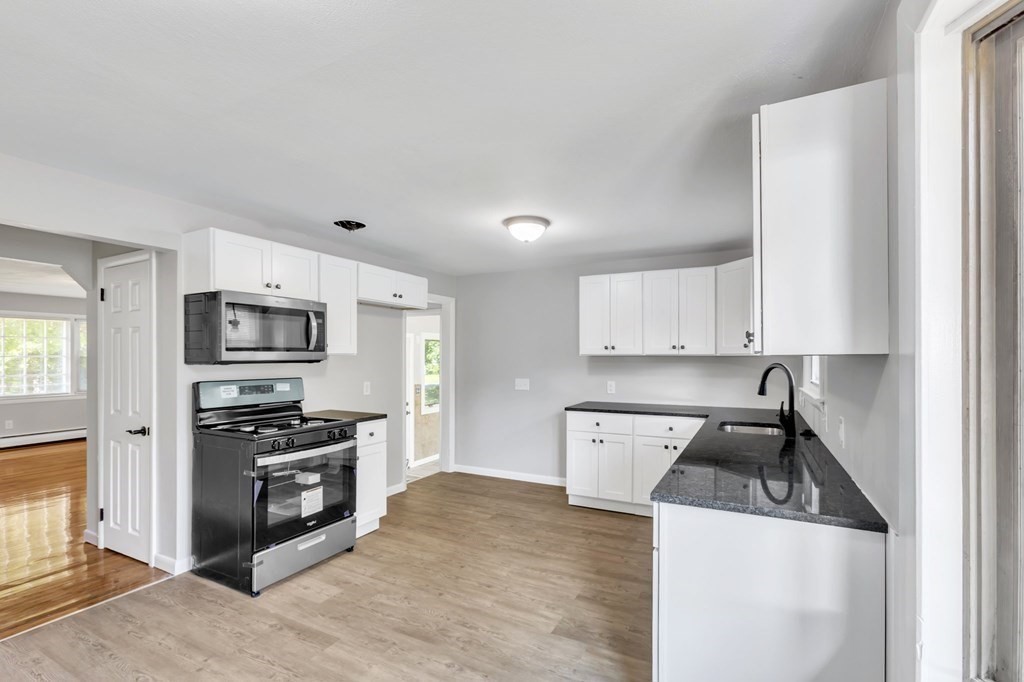 172 Garvey Drive Springfield, MA 01109 - Photo 5 of 28 a kitchen with stainless steel appliances granite countertop a sink stove and refrigerator