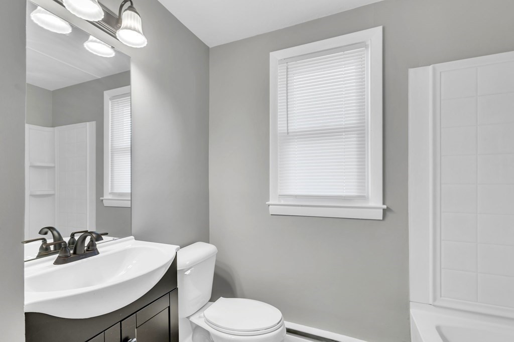 172 Garvey Drive Springfield, MA 01109 - Photo 9 of 28 a bathroom with a sink vanity mirror and toilet