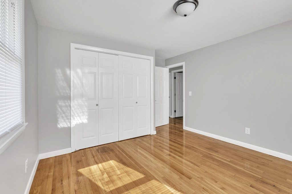 172 Garvey Drive Springfield, MA 01109 - Photo 10 of 28 an empty room with wooden floor and window