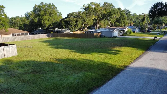 a view of a swimming pool with a garden and trees