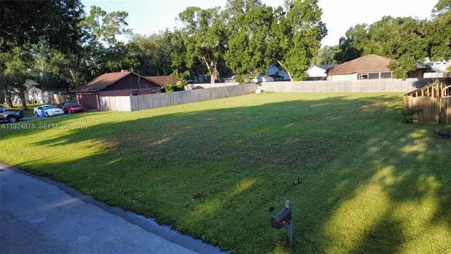 an aerial view of residential house with outdoor space and trees