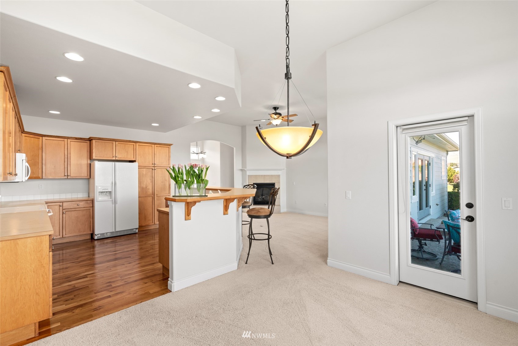 1845 Maple Street, Unit 9 Wenatchee, WA 98801 - Photo 13 of 20 a view of a kitchen with kitchen island dining table and wooden floor