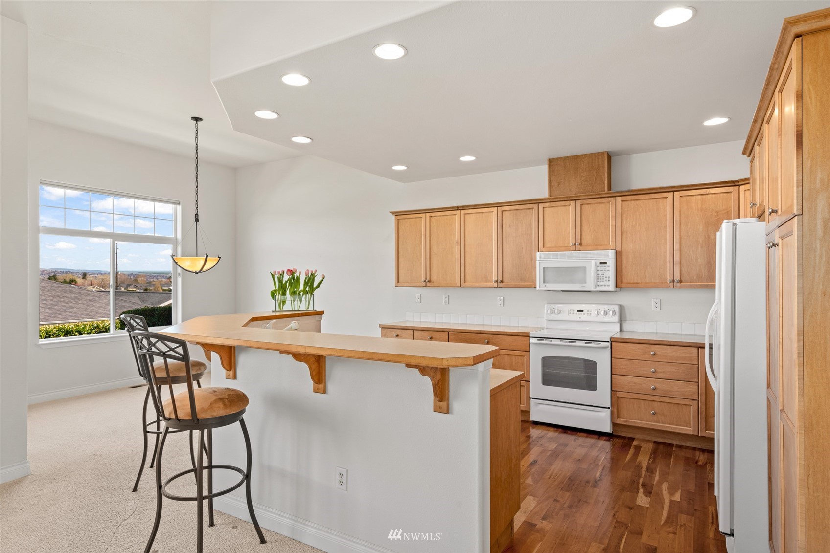 1845 Maple Street, Unit 9 Wenatchee, WA 98801 - Photo 7 of 20 a kitchen with stainless steel appliances kitchen island granite countertop a sink and cabinets