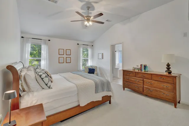 a bed room with a bed and a chandelier