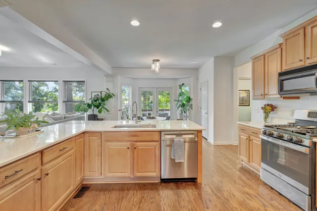 a kitchen with kitchen island granite countertop appliances cabinets and a counter space