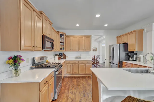 a kitchen with a sink stove and refrigerator