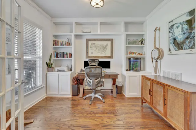 a living room with furniture and a table with wooden floor