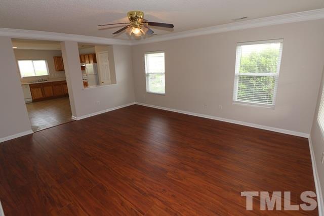 2620 Quarry Ridge Lane Raleigh, NC 27610 - Photo 2 of 25 a view of an empty room with wooden floor and a window