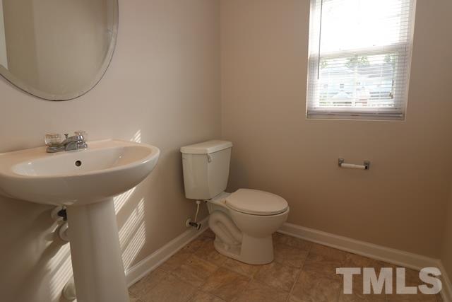 2620 Quarry Ridge Lane Raleigh, NC 27610 - Photo 18 of 25 a bathroom with a sink a toilet and a mirror