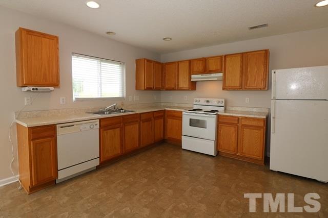 2620 Quarry Ridge Lane Raleigh, NC 27610 - Photo 5 of 25 a kitchen with a stove sink and cabinets