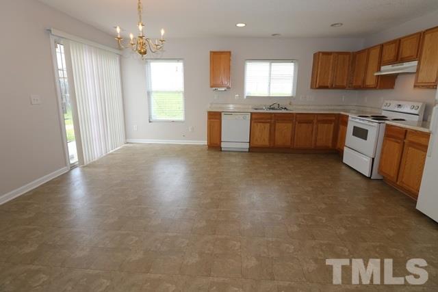 2620 Quarry Ridge Lane Raleigh, NC 27610 - Photo 6 of 25 a large kitchen with stainless steel appliances granite countertop a stove a sink dishwasher and a refrigerator