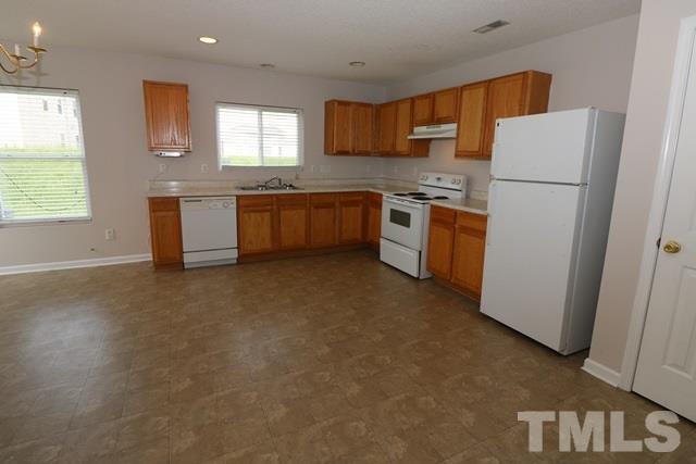 2620 Quarry Ridge Lane Raleigh, NC 27610 - Photo 7 of 25 a kitchen with a refrigerator sink and stove
