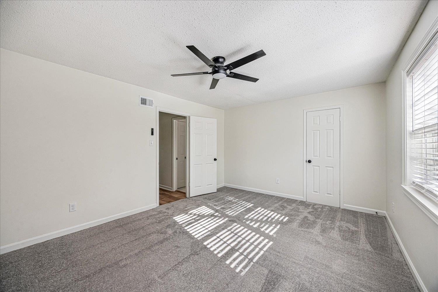 6452 Macon Road Memphis, TN 38134 - Photo 14 of 22 Unfurnished bedroom featuring carpet, a textured ceiling, and a ceiling fan