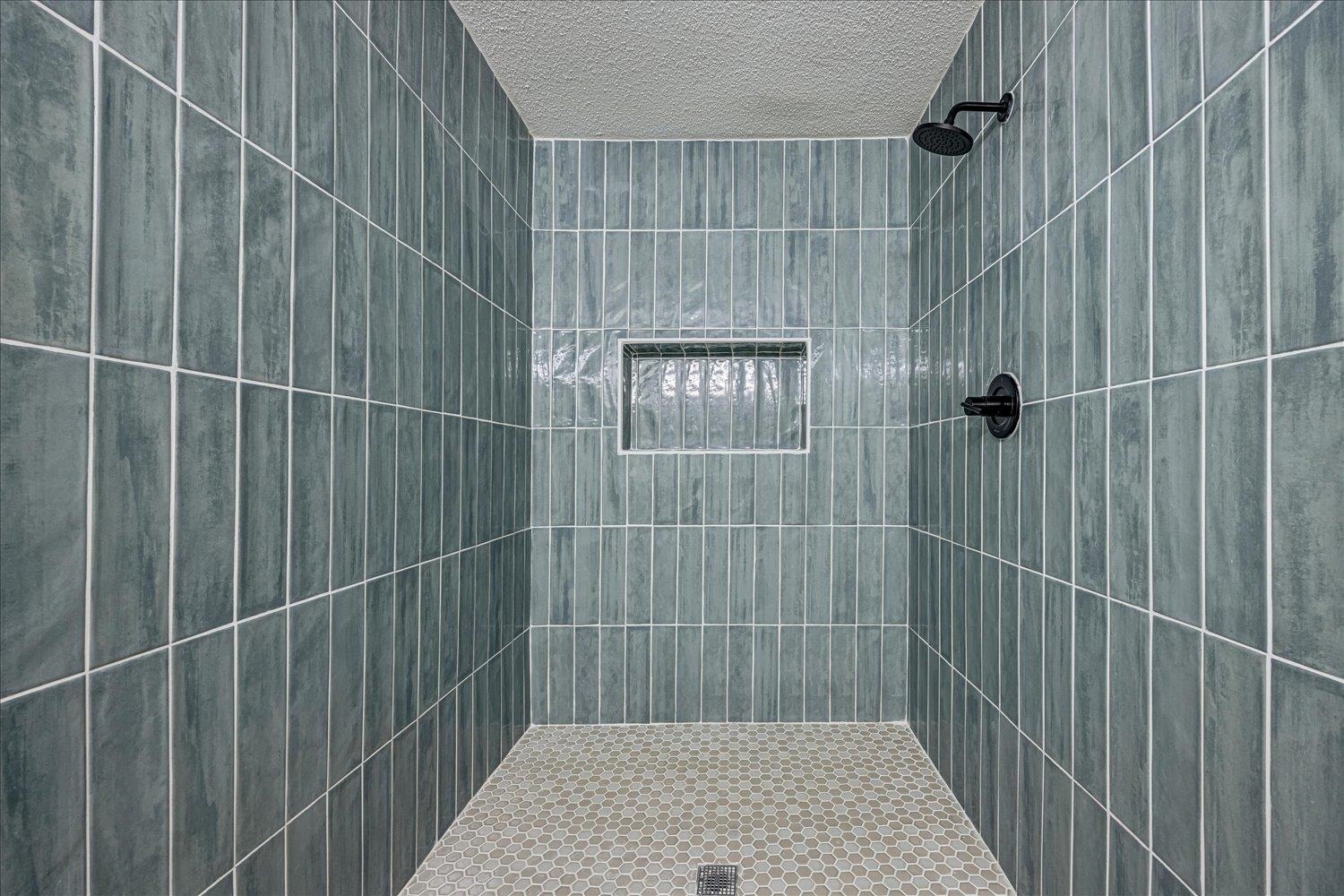 6452 Macon Road Memphis, TN 38134 - Photo 16 of 22 Bathroom featuring a tile shower and a textured ceiling