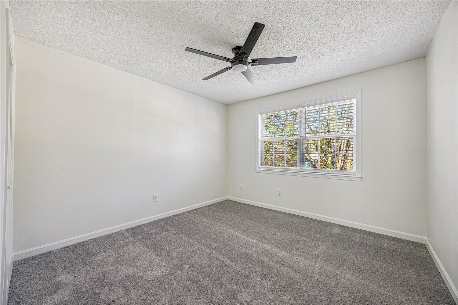 6452 Macon Road Memphis, TN 38134 - Photo 20 of 22 Empty room with dark colored carpet, a textured ceiling, and ceiling fan