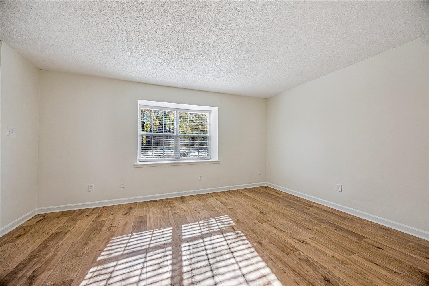 6452 Macon Road Memphis, TN 38134 - Photo 5 of 22 Empty room with a textured ceiling and light wood-type flooring