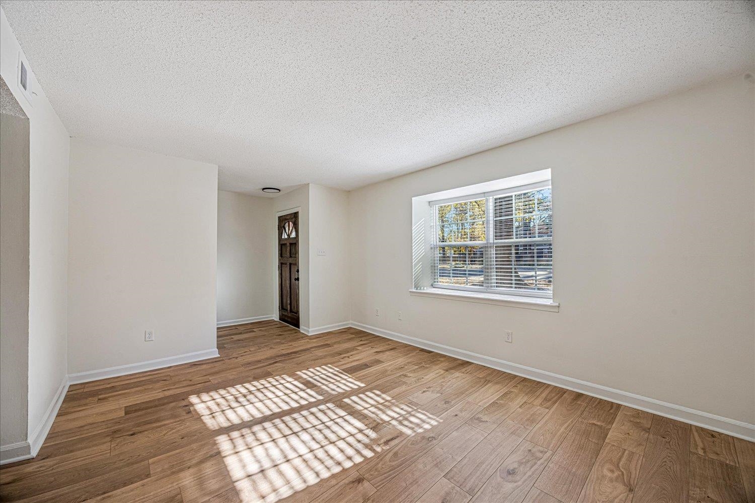6452 Macon Road Memphis, TN 38134 - Photo 6 of 22 Unfurnished room featuring a textured ceiling and light wood-style floors
