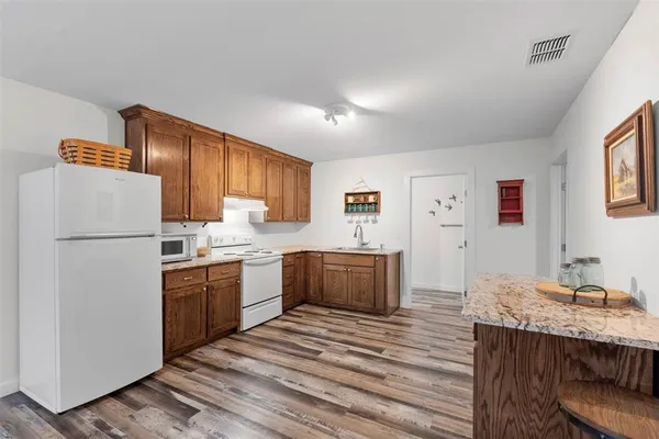 a kitchen with a refrigerator and a sink