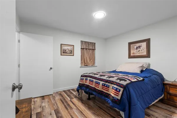 a bedroom with bed and a window