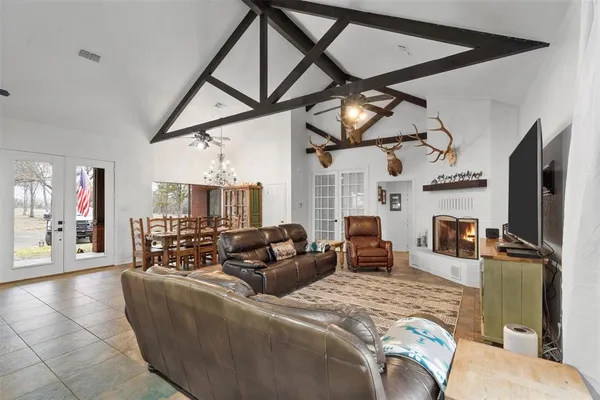 a living room with furniture a fireplace and a flat screen tv