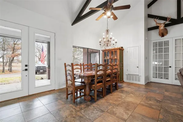 a view of a dining room with furniture and chandelier