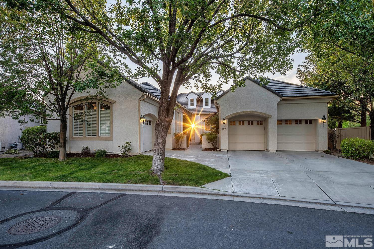 1689 Aspen Creek Road Reno, NV 89519 - Photo 1 of 40 a front view of a house with a yard and garage