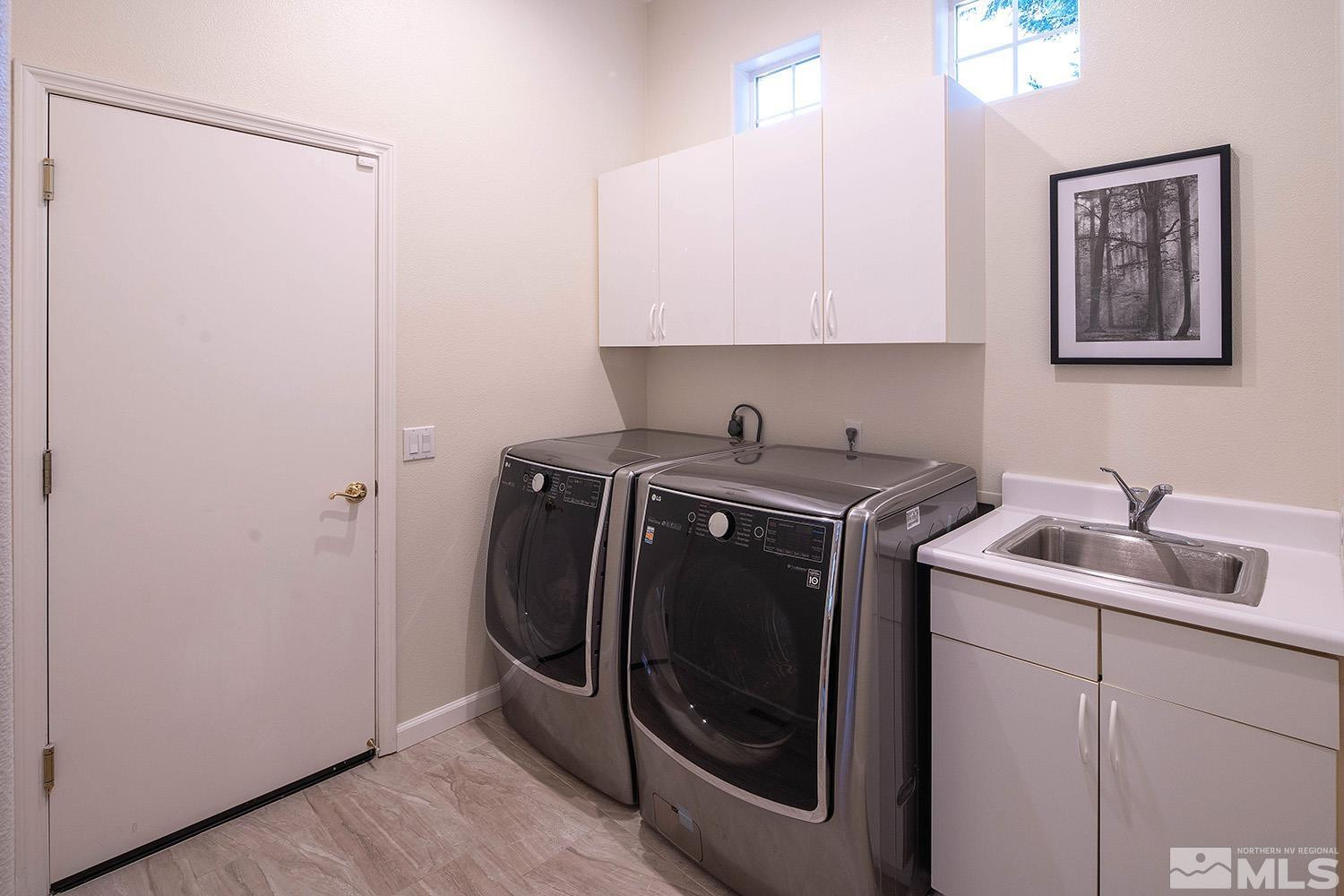 1689 Aspen Creek Road Reno, NV 89519 - Photo 33 of 40 a utility room with cabinets washer and dryer