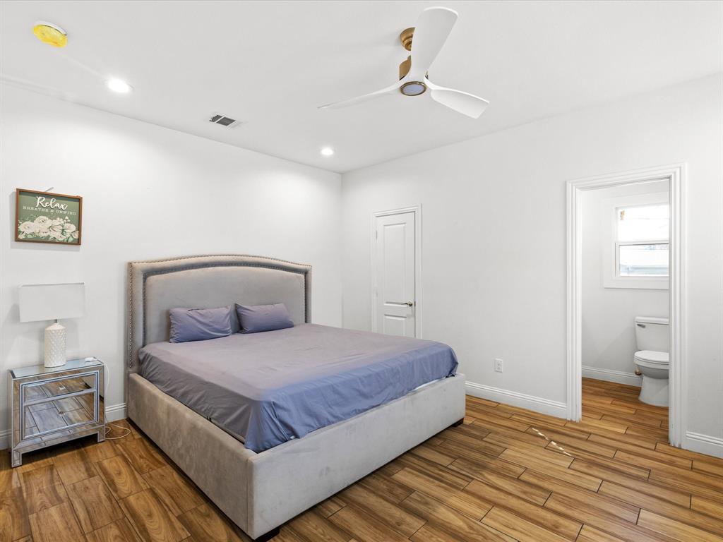 1304 East Mulkey Street Fort Worth, TX 76104 - Photo 14 of 19 a bedroom with a bed and a table