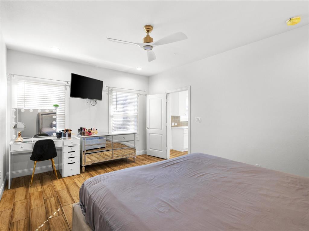 1304 East Mulkey Street Fort Worth, TX 76104 - Photo 15 of 19 a bedroom with a bed and a chandelier