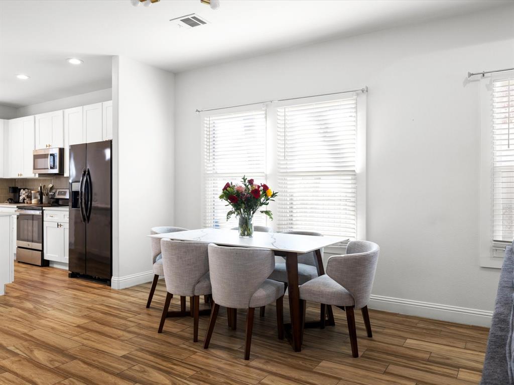 1304 East Mulkey Street Fort Worth, TX 76104 - Photo 7 of 19 a view of a dining room with furniture window and wooden floor