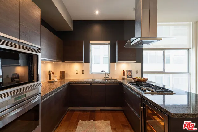 a kitchen with stainless steel appliances a sink stove and cabinets