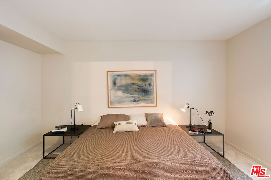 3119 Vía Dolce, Unit 302 Marina del Rey, CA 90292 - Photo 16 of 22 a bedroom with a bed and a painting on the wall
