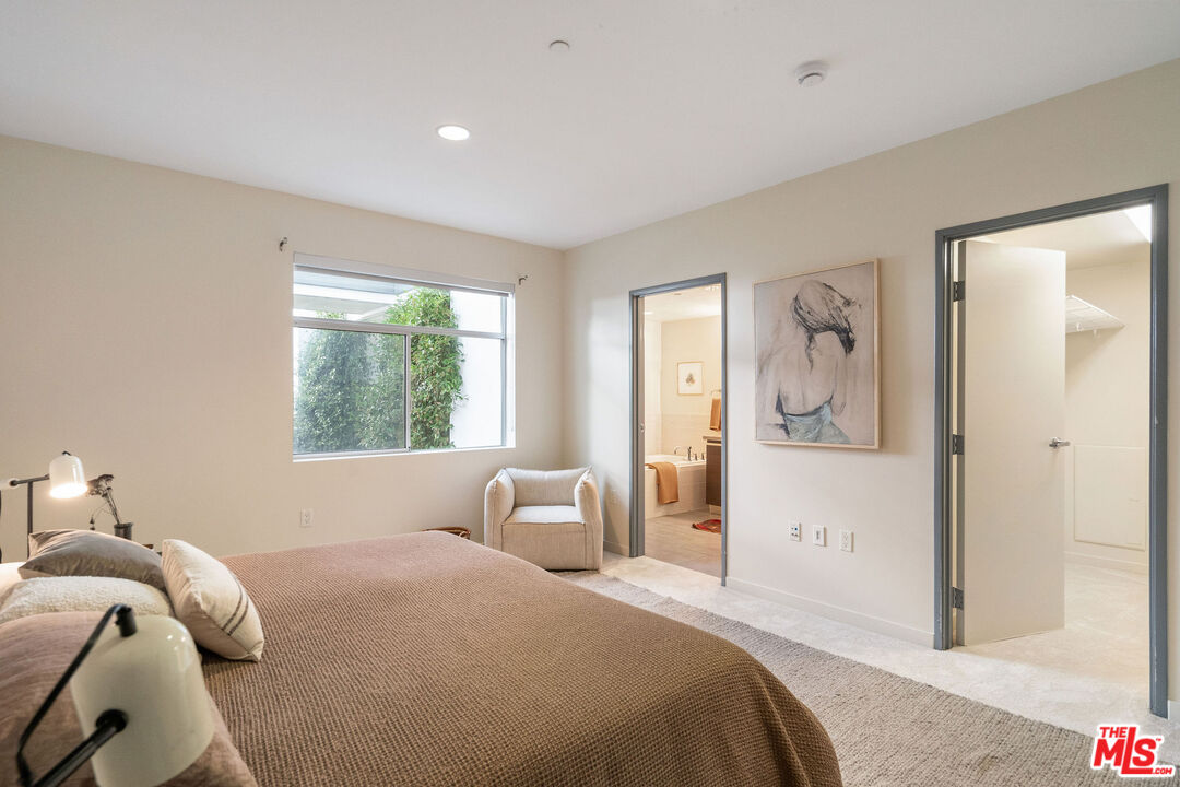 3119 Vía Dolce, Unit 302 Marina del Rey, CA 90292 - Photo 17 of 22 a bedroom with a large bed and a window