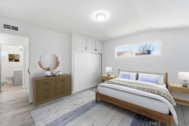 a bedroom with a bed and a dresser