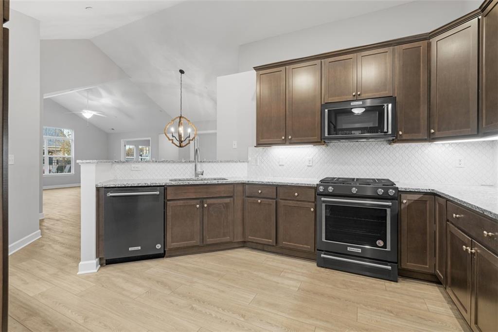 103 Spring Valley Drive Zelienople, PA 16063 - Photo 11 of 42 a kitchen with stainless steel appliances granite countertop a stove a sink and a microwave