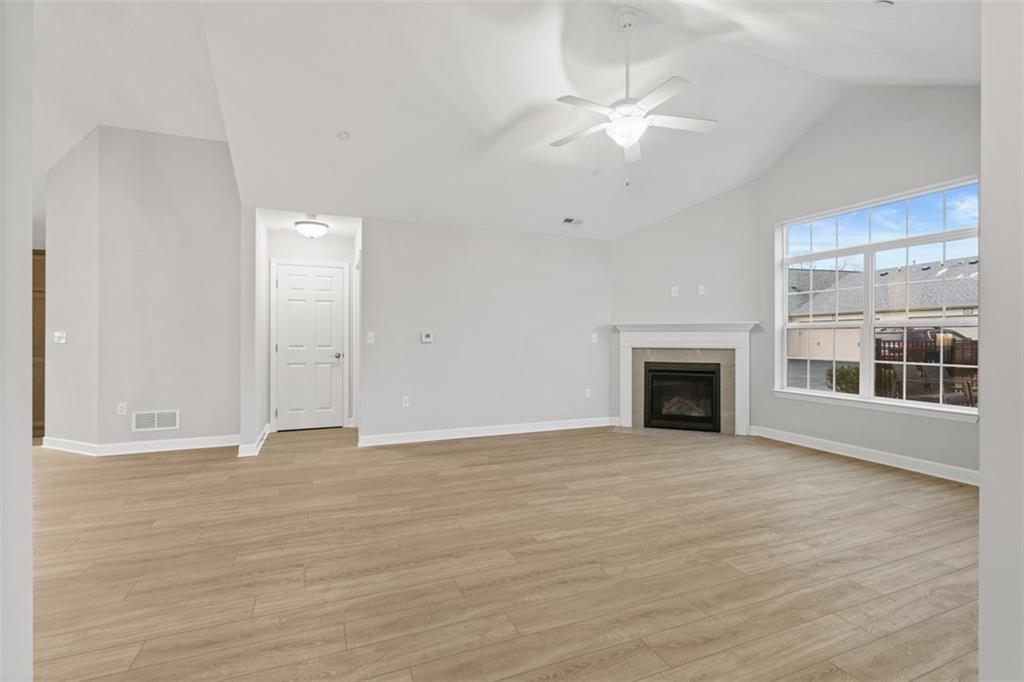 103 Spring Valley Drive Zelienople, PA 16063 - Photo 14 of 42 an empty room with wooden floor fireplace and windows