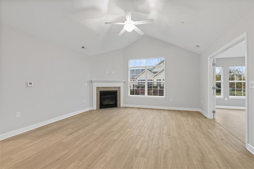 103 Spring Valley Drive Zelienople, PA 16063 - Photo 15 of 42 wooden floor fireplace and windows in an empty room
