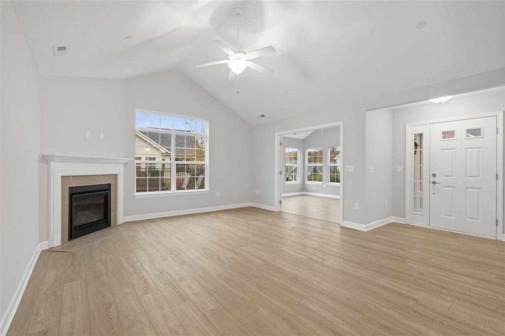 103 Spring Valley Drive Zelienople, PA 16063 - Photo 17 of 42 an empty room with wooden floor fireplace and windows