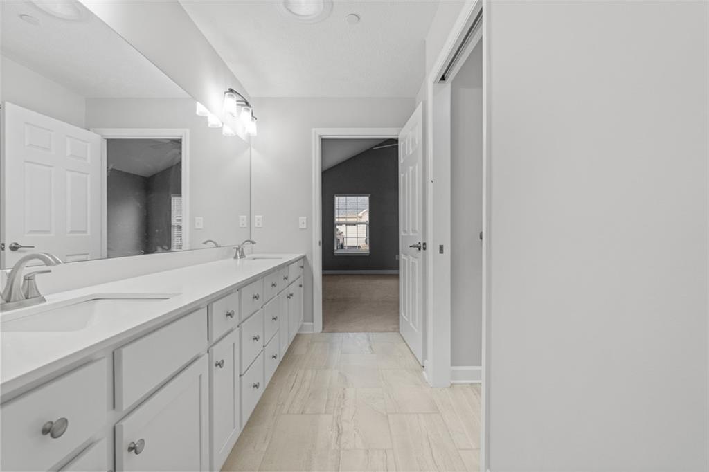 103 Spring Valley Drive Zelienople, PA 16063 - Photo 32 of 42 a spacious bathroom with a double vanity sink and a mirror