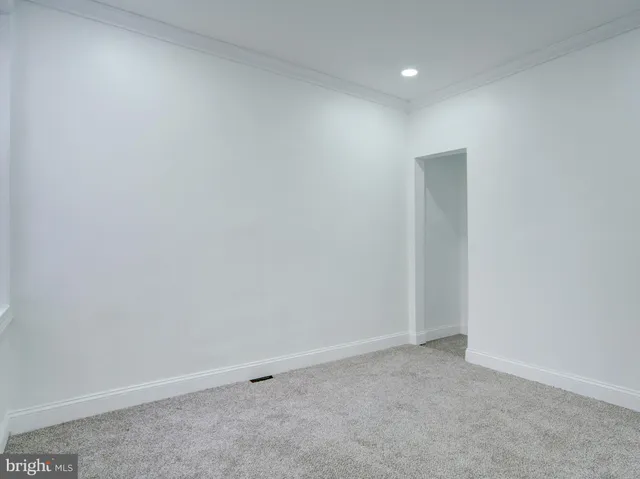 an empty room with closet area