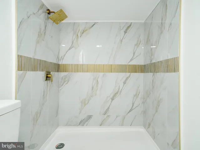 a front view of a building and car parked