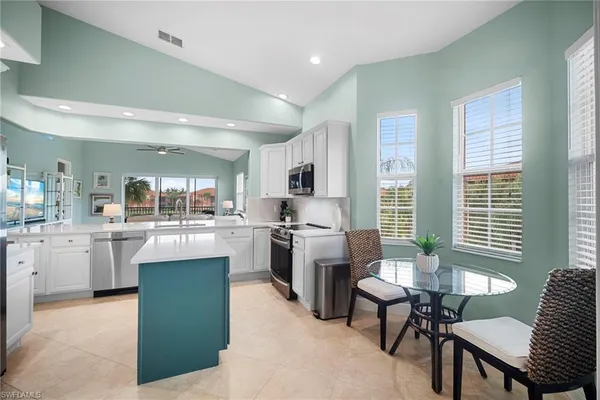a kitchen with sink cabinets and dining table