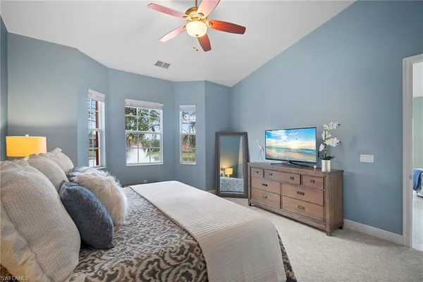 a bedroom with a bed and a television