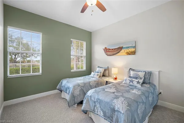 a bedroom with two beds and a window